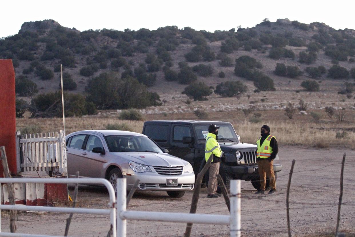 Security stands at the entrance to a film set where police say actor Alec Baldwin fired a prop gun, killing a cinematographer, is seen outside Santa Fe, New Mexico, Friday, Oct. 22, 2021. The Bonanza Creek Ranch film set has permanent structures for background used in Westerns, including "Rust," the film Baldwin was working on when the prop gun discharged.