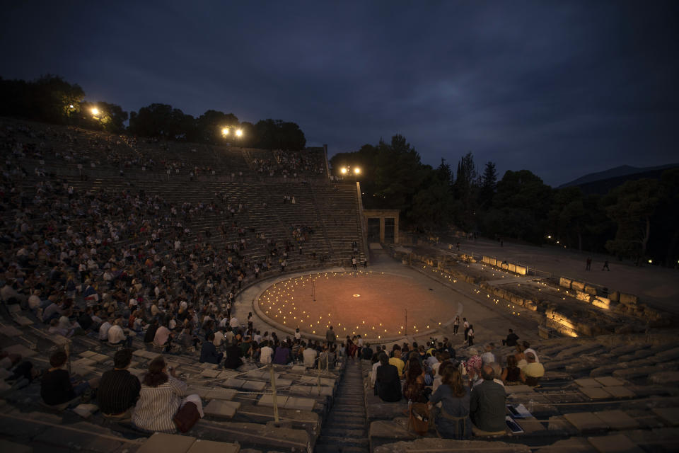 Spectators sit at the ancient theater of Epidaurus, during a concert, on Friday, July 17, 2020. Greek Culture Ministry allowed the ancient theaters of Epidaurus in southern Greece and Herodes Atticus in Athens to host performances under strict safety guidelines due the COVID-19 pandemic.(AP Photo/Petros Giannakouris)