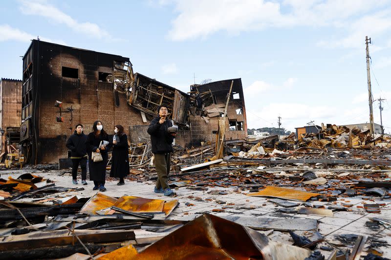 Japanese lacquer artist Kohei Kirimoto searches for his cats, in the aftermath of an earthquake, in Wajima