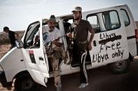 Libyan rebel fighters arrive at the front line near the southwest desert hamlet of Gualish on July 24. Libya on Monday accused NATO of killing at least seven people in an air raid on a medical clinic in Zliten east of Tripoli, as the top US officer spoke of "stalemate" in NATO's campaign