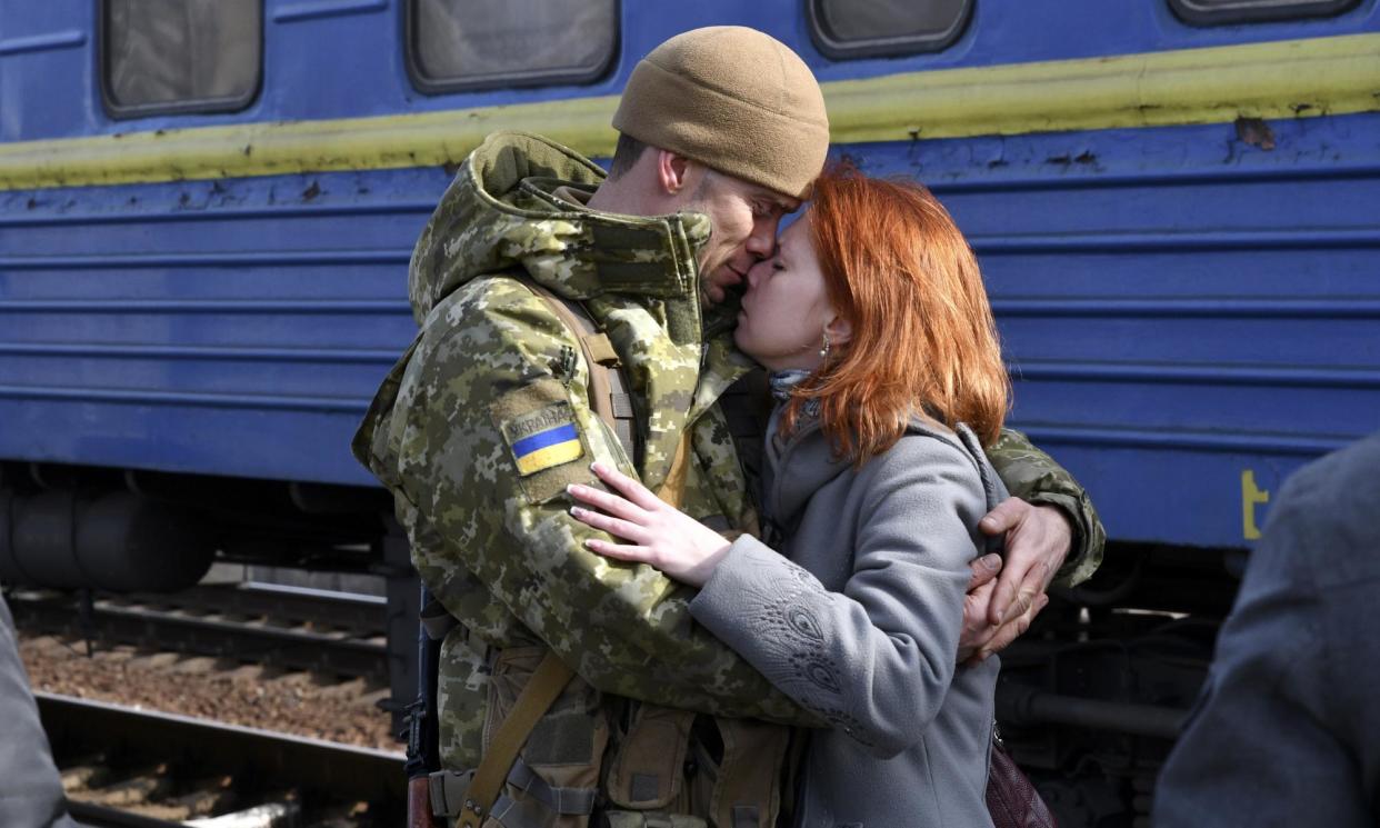 <span>A couple embrace at a station in Kramatorsk, Ukraine, in 2022.</span><span>Photograph: Andriy Andriyenko/AP</span>