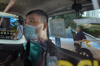 FILE - In this July 6, 2020, file photo, Tong Ying-kit arrives at a court in a police van in Hong Kong. Tong, accused of driving a motorcycle into police officers while carrying a Hong Kong protest flag became on Wednesday, June 23, 2021 the first person to stand trial under the national security law implemented last year as China's central government tightened control over the city. (AP Photo/Vincent Yu, File)