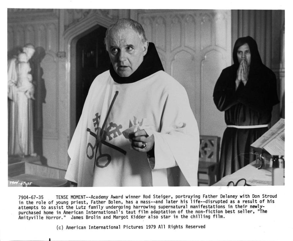 a priest and a clergymen standing behind him