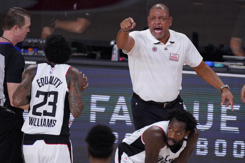 Los Angeles Clippers head coach Doc Rivers, right, directs his team during the second half of an NBA conference semifinal playoff basketball game Monday, Sept. 7, 2020, in Lake Buena Vista, Fla. (AP Photo/Mark J. Terrill)