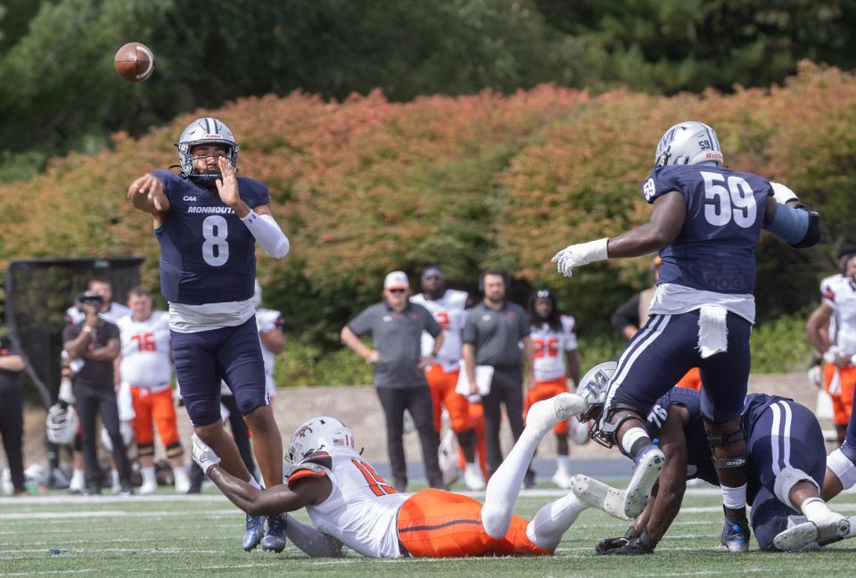 Monmouth quarterback Marquez McCray gets off a pass before being pulled down in early game action. Monmouth University Football battles Campbell in a home game in West Long Branch on September 16, 2023.