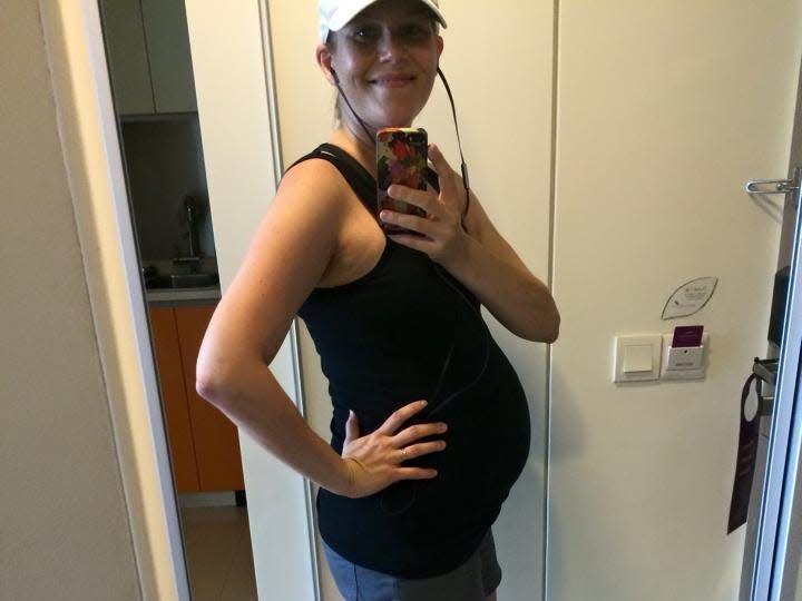 Pregnant woman taking picture in the mirror