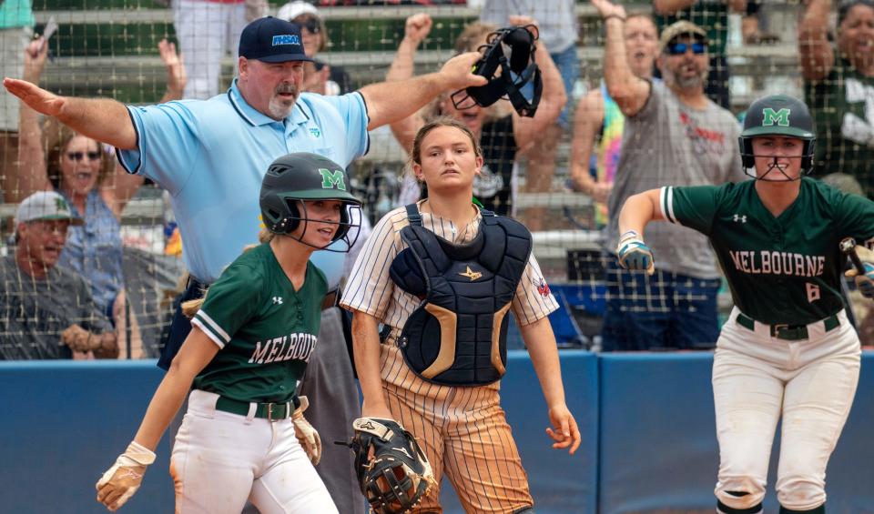 Melbourne's Hailey Turner (5) reacts after scoring the winning run in the top of the ninth inning as Bartow catcher McKenzie Gibson and Melbourne's Baylea Holland (6) look on.