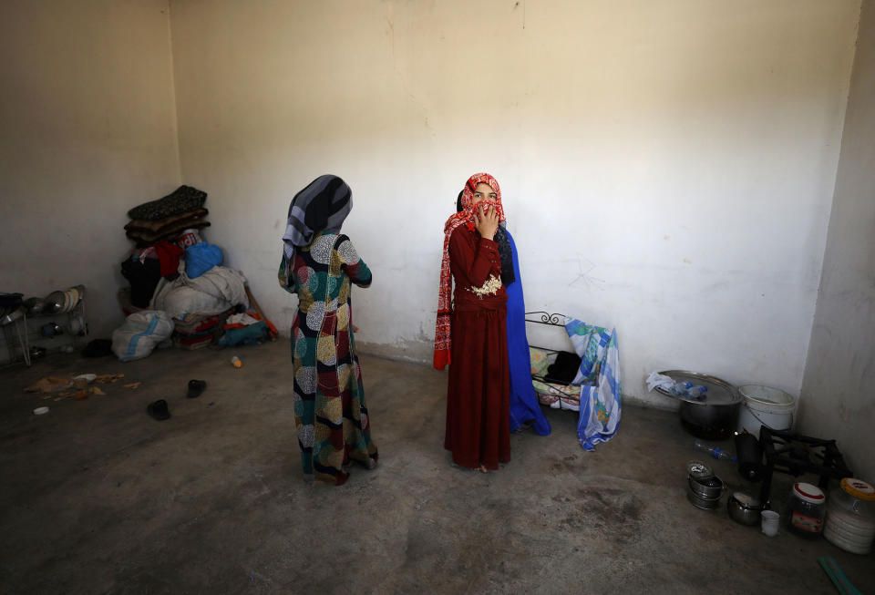 Civilians are pictured inside their home