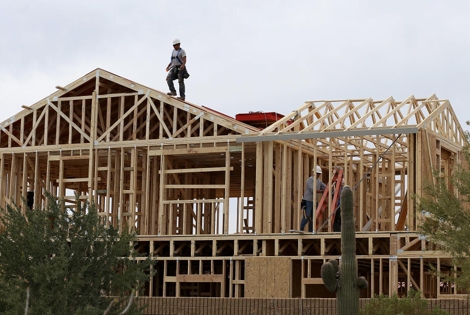 PHOENIX, AZ - MARCH 05:  A worker climbs on the roof of a home under construction at the Pulte Homes Fireside at Norterra-Skyline housing development in Phoenix, Arizona. (Photo by Justin Sullivan/Getty Images)