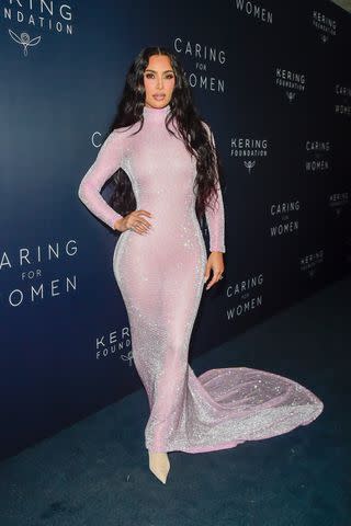 <p>Raymond Hall/GC Images</p> The dramatic train of Kim Kardashian's blush-pink gown was a show-stopping moment