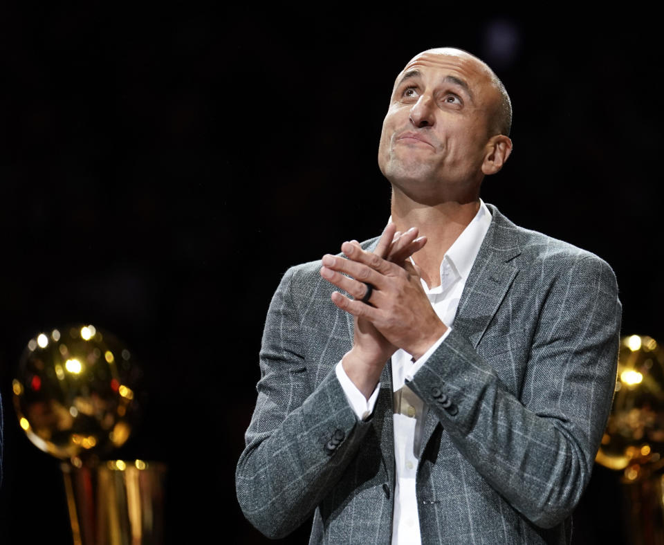 FILE - Former San Antonio Spurs guard Manu Ginobili watches as his jersey is unveiled in the rafters of the AT&T Center during his retirement ceremony after the Spurs' NBA basketball game against the Cleveland Cavaliers, Thursday, March 28, 2019, in San Antonio. The four-time NBA champion with the Spurs is one of the headliners for Saturday night’s enshrinement ceremony in Springfield, Massachusetts. (AP Photo/Darren Abate, File)