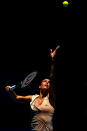 Out of the darkness and into the light, Flavia Penetta prepares to serve.