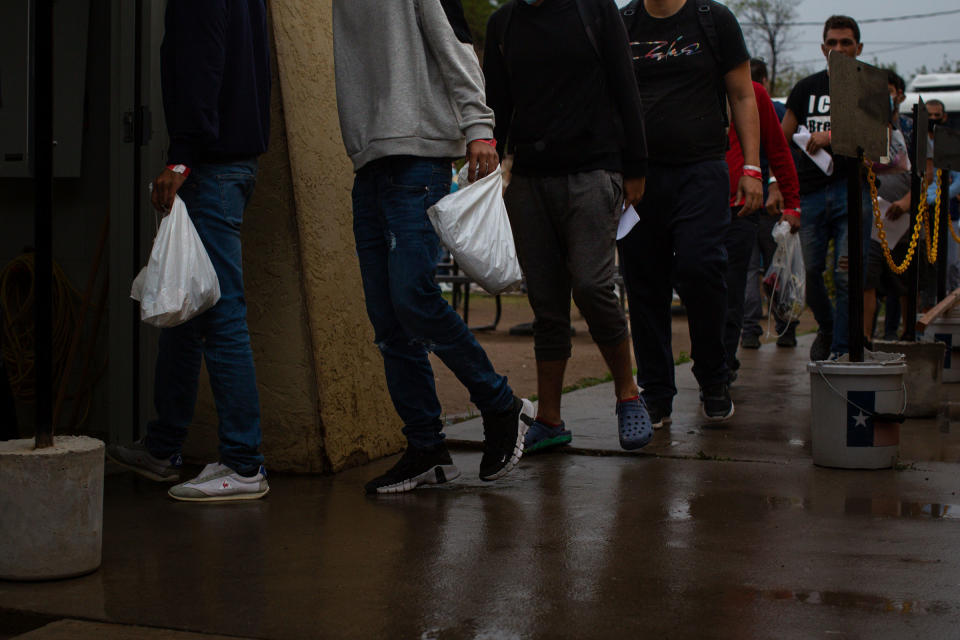 Migrants arrive at the Val Verde Border Humanitarian Coalition carrying plastic bags tagged with Department of Homeland Security baggage check forms and missing shoelaces in Del Rio, Texas, on Aug. 15, 2022.<span class="copyright">Kaylee Greenlee Beal for TIME</span>