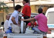 Syrian people leave the city center after shelling by Syrian government forces in Syria's restive northern city of Aleppo. Fighting raged in Syria's second city on Thursday as troops and rebels prepared for a head-on confrontation and pro-regime media warned of a looming "mother of all battles."