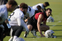 Las Vegas Raiders quarterback Derek Carr (4) stretches during an NFL football practice Tuesday, June 15, 2021, in Henderson, Nev. (AP Photo/John Locher)