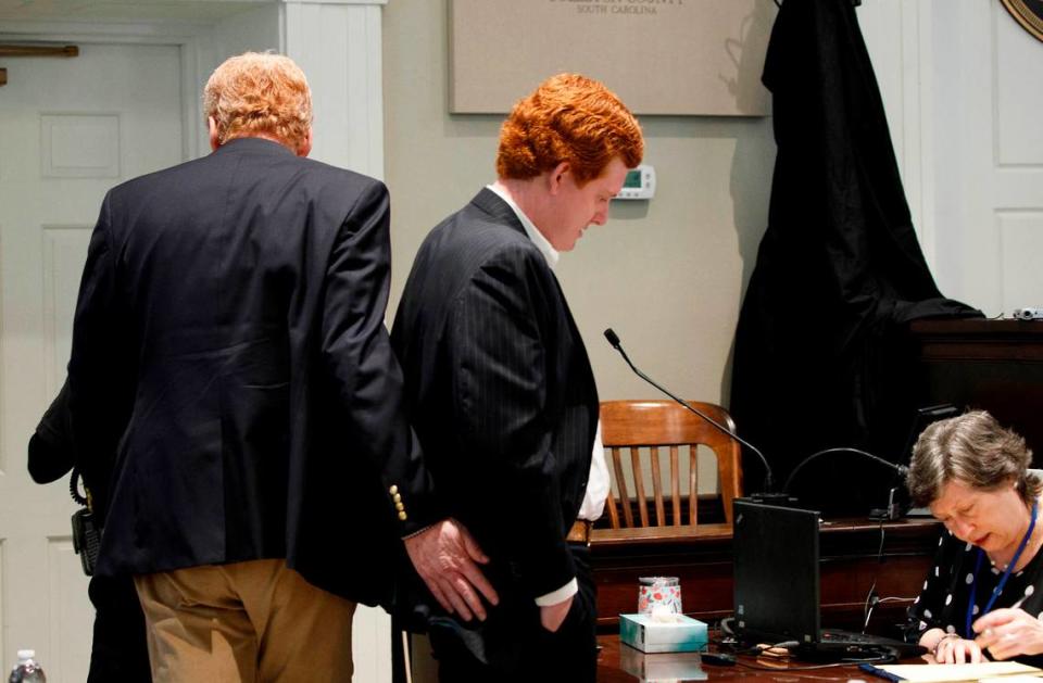 Alex Murdaugh gives his son Buster Murdaugh a pat during a break in testimony during trial at the Colleton County Courthouse in Walterboro, Tuesday, Feb. 21, 2023. Grace Beahm Alford/The Post and Courier/Pool