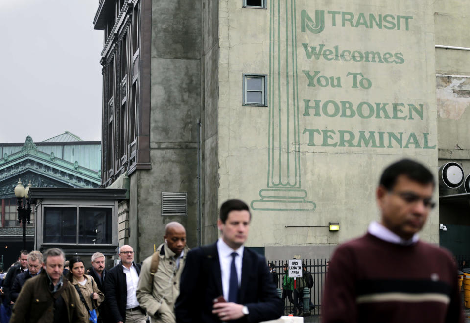 Commuters make their way to buses bound for New York City in Hoboken, N.J., Tuesday, April 4, 2017. A minor derailment on Monday at Penn Station involving a New Jersey Transit train and other rail issues are causing major problems for New York City metro area commuters. (AP Photo/Seth Wenig)