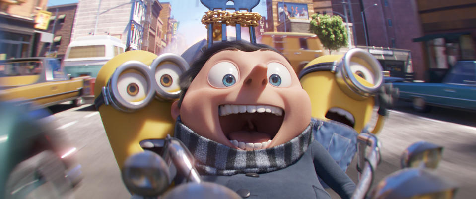 This image released by Universal Pictures shows characters, from left, Kevin, Gru, voiced by Steve Carell, and Stuart in a scene from "Minions: The Rise of Gru." (Illumination Entertainment/Universal Pictures via AP)