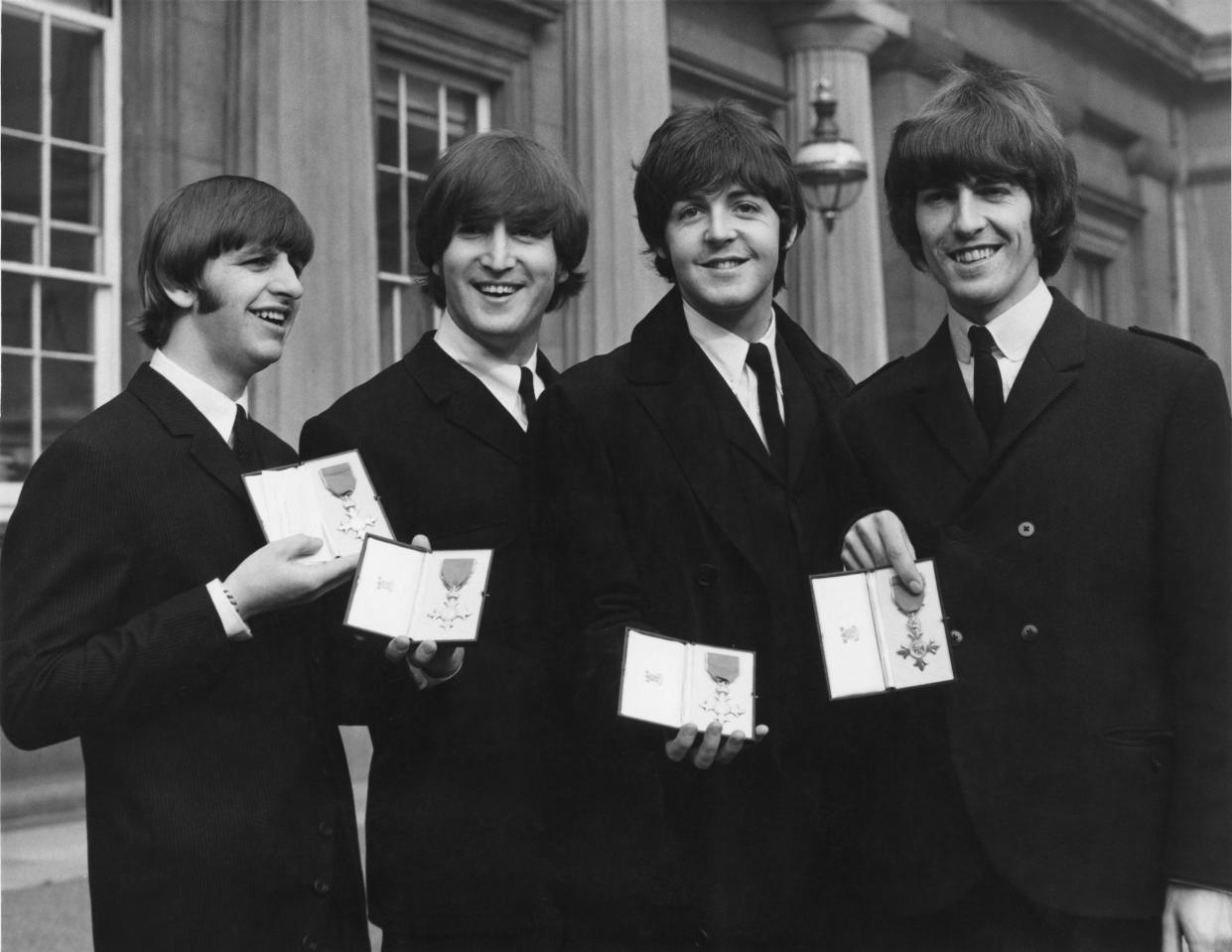 British rock group the Beatles after each received an MBE at Buckingham Palace in London, 26th October 1965. From left to right, Ringo Starr, John Lennon, Paul McCartney, George Harrison. (Photo by William Vanderson/Fox Photos/Hulton Archive/Getty Images)