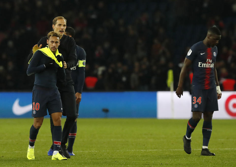 PSG's coach Thomas Tuchel congratulates PSG's Neymar, left, after winning the League One soccer match between Paris Saint-Germain and Lille 2-1 at the Parc des Princes stadium in Paris, Friday, Nov. 2, 2018. (AP Photo/Thibault Camus)