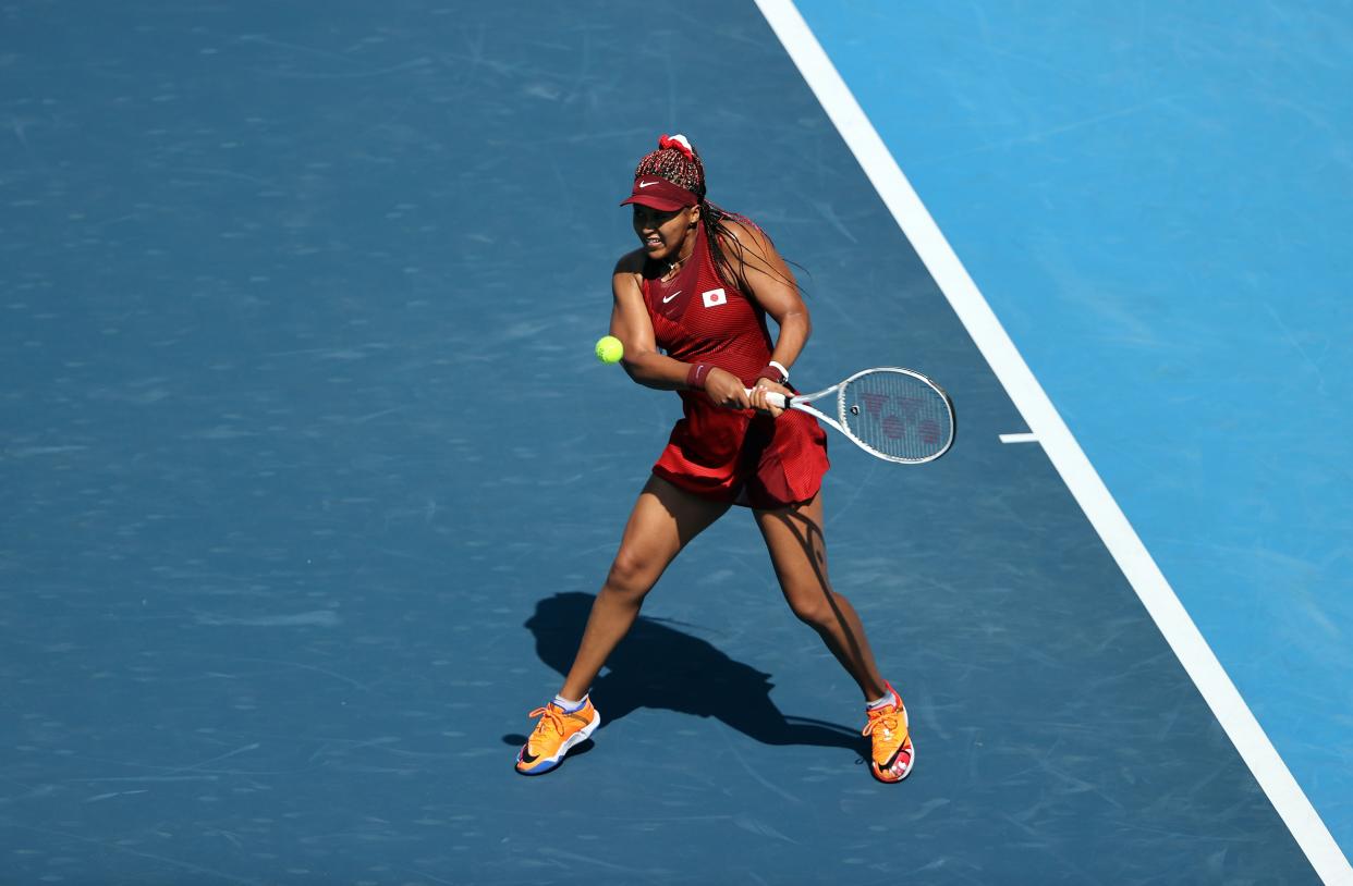 Naomi Osaka of Team Japan plays a backhand during her Women's Singles First Round match against Saisai Zheng of Team China on day two of the Tokyo 2020 Olympic Games at Ariake Tennis Park on July 25, 2021, in Tokyo, Japan.