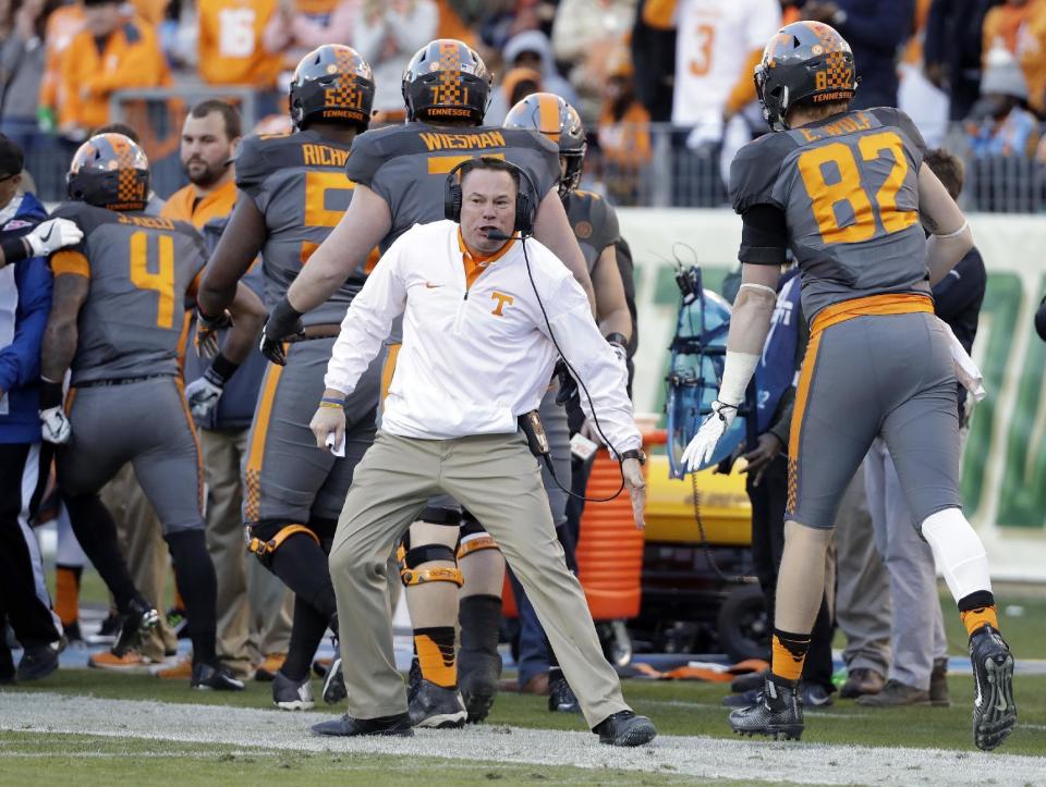 Tennessee head coach Butch Jones congratulates players after Tennessee scored against Nebraska in the first half of the Music City Bowl NCAA college football game Friday, Dec. 30, 2016, in Nashville, Tenn. (AP Photo/Mark Humphrey)