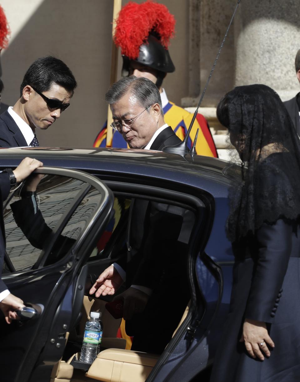 South Korean President Moon Jae-in, center, and his wife Kim Jung-sook, right, get into a car after their private audience with Pope Francis, at the Vatican, Thursday, Oct. 18, 2018. South Korea's president is in Italy for a series of meetings that will culminate with an audience with Pope Francis at which he's expected to extend an invitation from North Korean leader Kim Jong Un to visit. (AP Photo/Andrew Medichini)