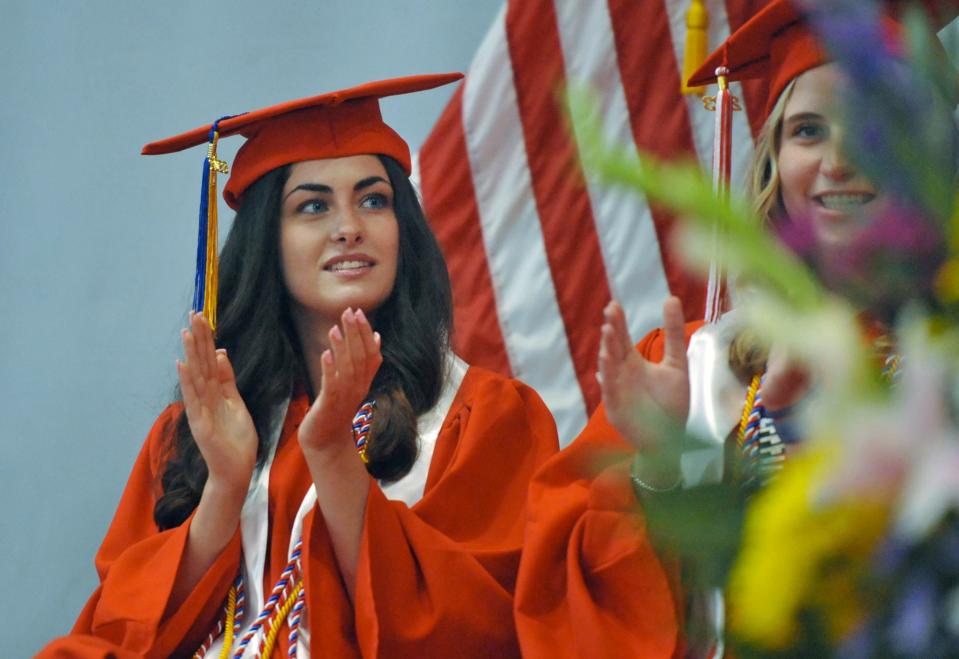 Emily King applauds during the Milton High School graduation.