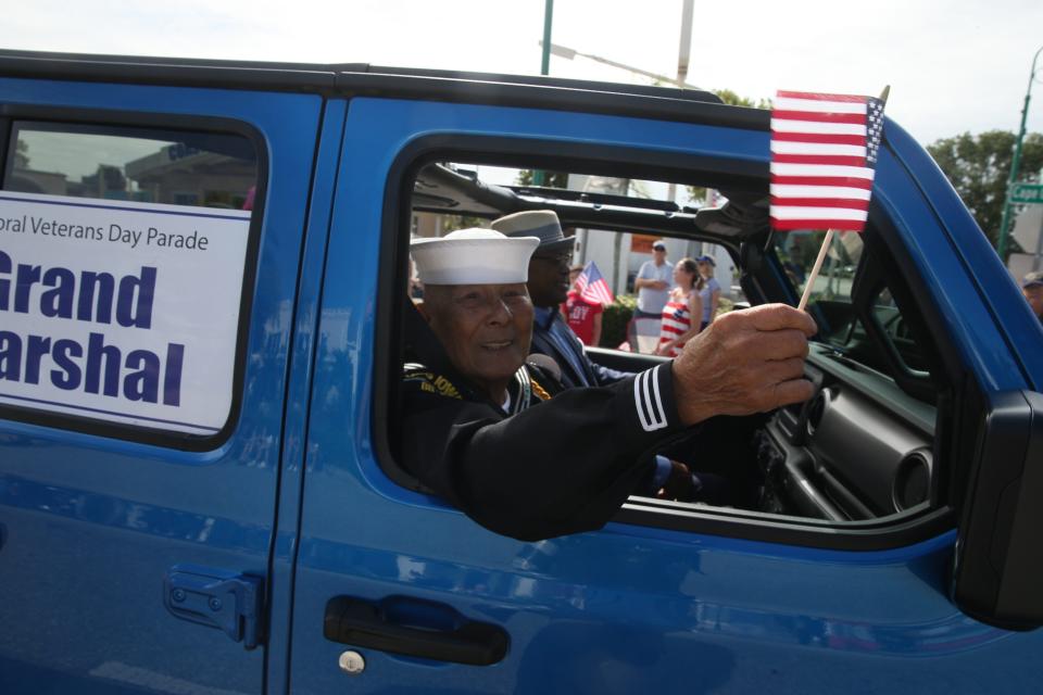 Fame Academia waves to the crowd during the Cape Coral Veterans Day Parade on Thursday, Nov 11, 2021.  He served in the U.S. Merchant Marine during the end of WWII and in the Navy during the Korean War and Vietnam. He was the the grand marshal.