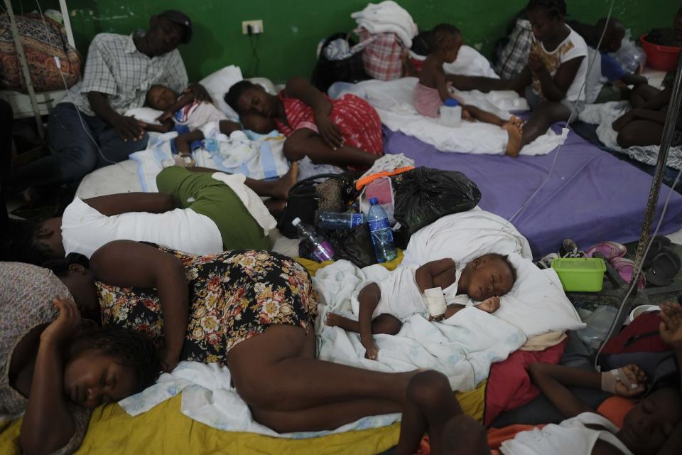 Injured children and their parents sleep on mattresses, on the floor of the Immaculee Conception hospital, in Les Cayes, Haiti, Monday, Aug. 23, 2021, a week after a 7.2 magnitude earthquake hit the area. (AP Photo/Matias Delacroix)