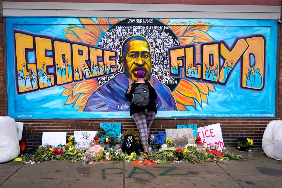 FILE – Damarra Atkins pays respect to George Floyd at a mural at George Floyd Square in Minneapolis, April 23, 2021. Tou Thao, the last former Minneapolis police officer convicted in state court for his role in the killing of George Floyd, has been sentenced to 4 years and 9 months on Monday, Aug. 7, 2023, even as he denied wrongdoing. (AP Photo/Julio Cortez, File)