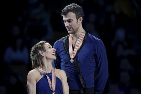 Gold medalists Meagan Duhamel and Eric Radford of Canada wait on the medal stand. REUTERS/Brian Snyder