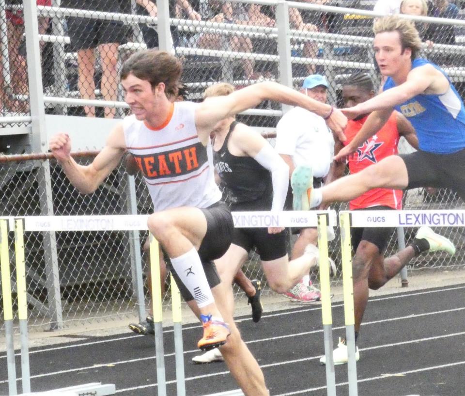 Heath senior Huntyr Butler races in the 110 hurdles during the Division II regional championships at Lexington on Saturday, May 28, 2022. Butler ran a regional-record time of 14.03 to win the event and qualify for state.