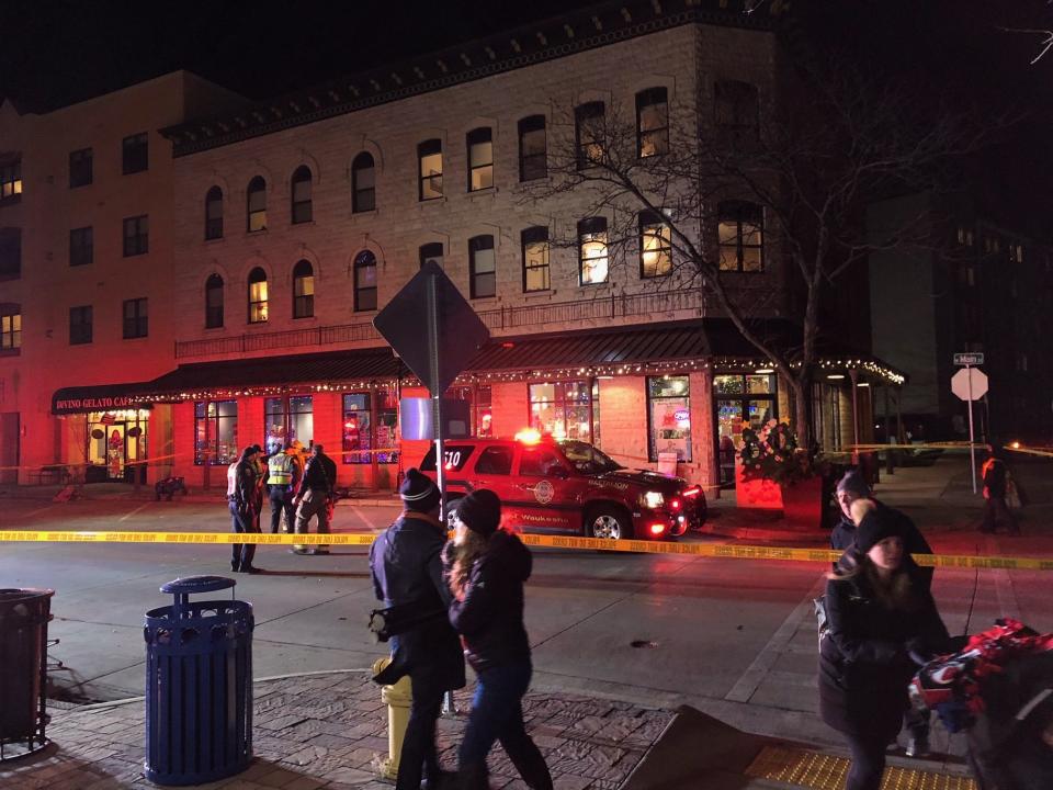 People leave the area in downtown Waukesha after a car reportedly rammed through the parade on Sunday.