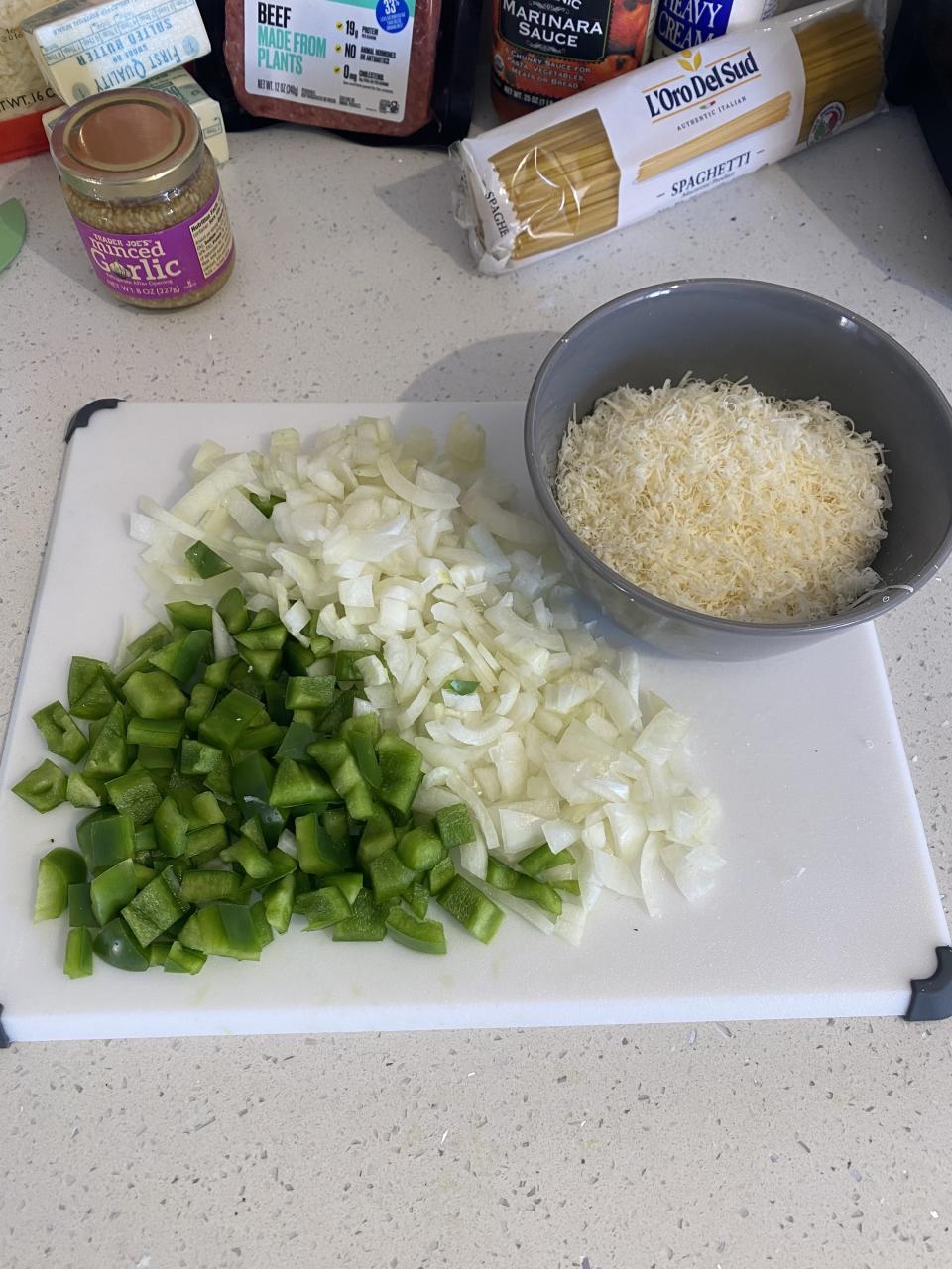 chopped up veggies and a bowl of cheese