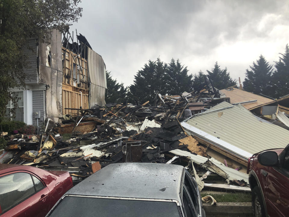 The site of a fire in Woodlawn, Md., where three people were killed, including a suspect, and two others were injured on Saturday, May 8, 2021. Around 6:40 a.m., officers responded to reports of both a fire and active shooter in Woodlawn, Baltimore County Police spokeswoman Joy Stewart said at a news conference. (AP Photo/Brian Witte)