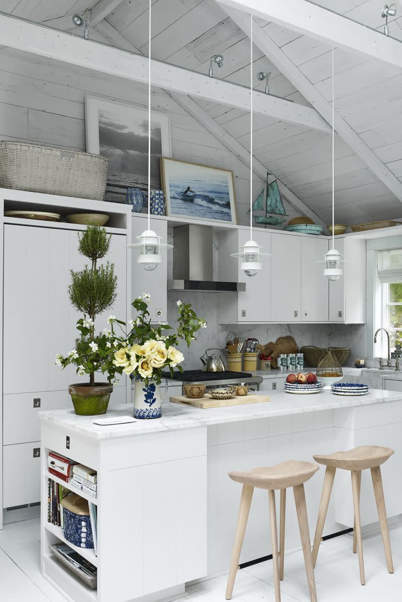 a kitchen with white cabinets and a white counter top