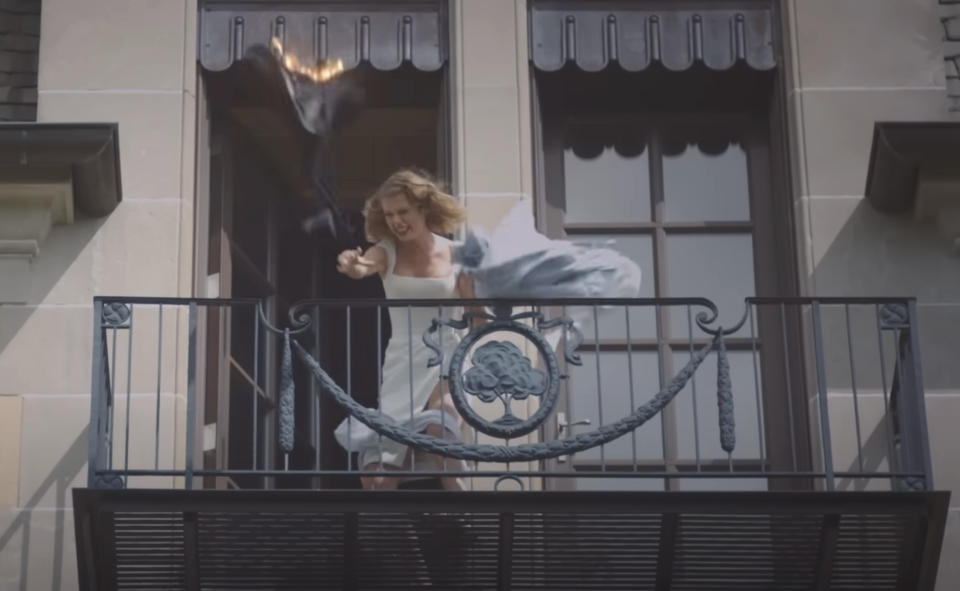 Taylor Swift throwing stuff off a balcony