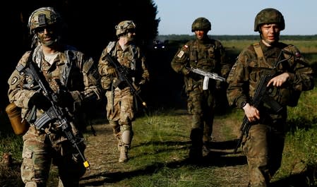 FILE PHOTO: Poland's 6th Airborne Brigade soldiers walk with U.S. 82nd Airborne Division soldiers during the NATO allies' Anakonda 16 exercise near Torun