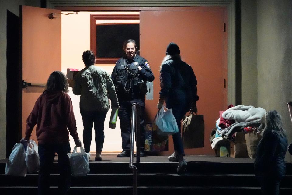 Supplies are carried into a family reunification center after a shooting Monday, Jan. 23, 2023, in Half Moon Bay, California.