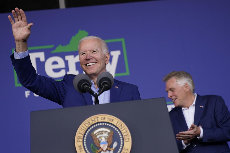 President Joe Biden waves as he arrives to speak at a campaign event for Virginia democratic gubernatorial candidate Terry McAuliffe, right, at Lubber Run Park, Friday, July 23, 2021, in Arlington, Va. (AP Photo/Andrew Harnik)