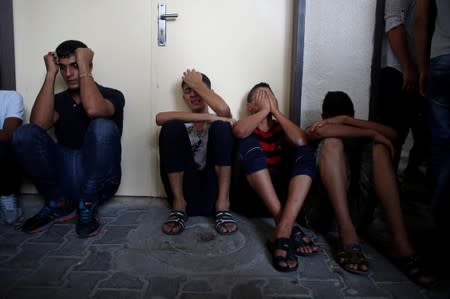 Relatives of Palestinian gunmen who were killed by Israeli forces as they tried to cross the Gaza border, react at a hospital in the northern Gaza Strip