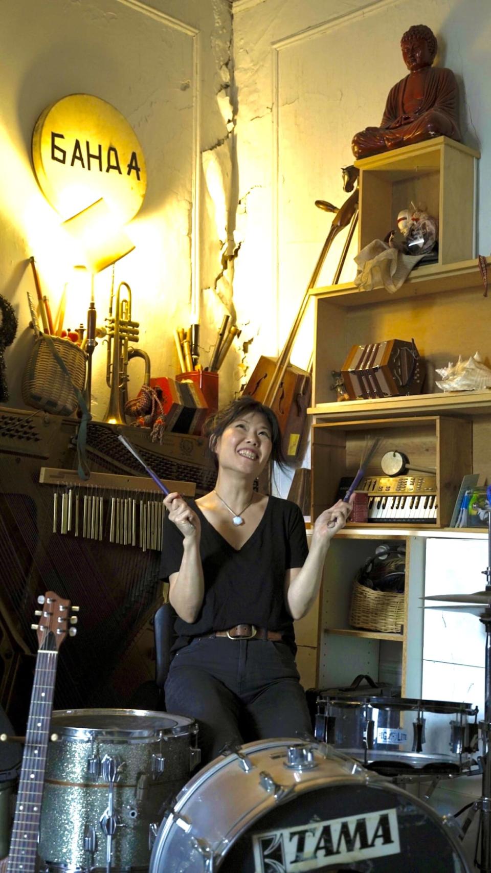 <div class="inline-image__caption"> <p>Susan Hwang playing the drums in her apartment</p> </div> <div class="inline-image__credit"> Xintian Wang </div>