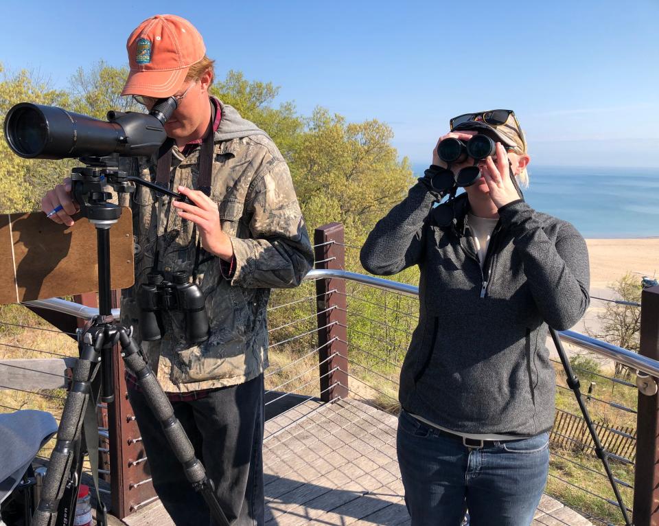 Kyle Wiktor, left, watches for and counts birds from the viewing tower at Indiana Dunes State Park during the 2021 Indiana Dunes Birding Festival. He is once again blogging about his spring bird counts from the tower.