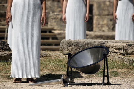 Greek actress Katerina Lehou, playing the role of High Priestess, and other prietesses stand by a parabolic mirror during the dress rehearsal for the Olympic flame lighting ceremony for the Rio 2016 Olympic Games at the site of ancient Olympia in Greece, April 20, 2016. REUTERS/Yannis Behrakis