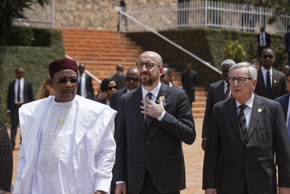 Prime Minister of Belgium Charles Michel, center, President of the European Commission Jean-Claude Juncker, right, and President of Congo-Brazzaville Denis Sassou Nguesso, left, arrive to lay wreaths at the Kigali Genocide Memorial in Kigali, Rwanda Sunday, April 7, 2019. Rwanda is commemorating the 25th anniversary of when the country descended into an orgy of violence in which some 800,000 Tutsis and moderate Hutus were massacred by the majority Hutu population over a 100-day period in what was the worst genocide in recent history. (AP Photo/Ben Curtis)