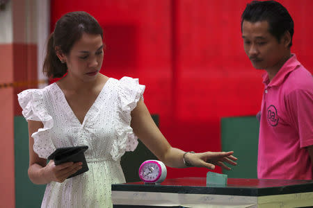 A voter casts their ballot for the general election at a polling station in Bangkok, Thailand, March 24, 2019. REUTERS/Athit Perawongmetha