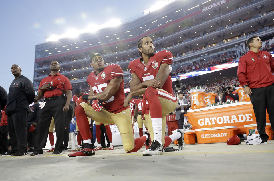 Image: San Francisco 49ers safety Eric Reid (35) and quarterback Colin Kaepernick (7) kneel during the national anthem (Marcio Jose Sanchez / AP file)