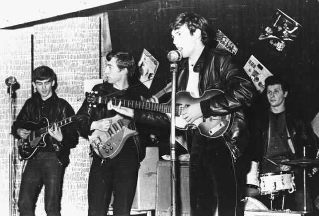 <p>Hulton Archive/Getty</p> The Beatles perform in a club in Liverpool, England, in 1962.