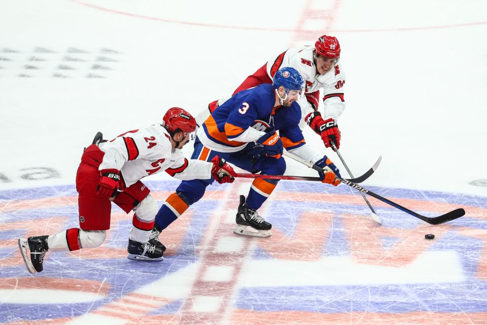 Apr 27, 2024; Elmont, New York, USA; New York Islanders defenseman Adam Pelech (3) skates past Carolina Hurricanes left wing Teuvo Teravainen (86) and center Seth Jarvis (24) in overtime in game four of the first round of the 2024 Stanley Cup Playoffs at UBS Arena.
